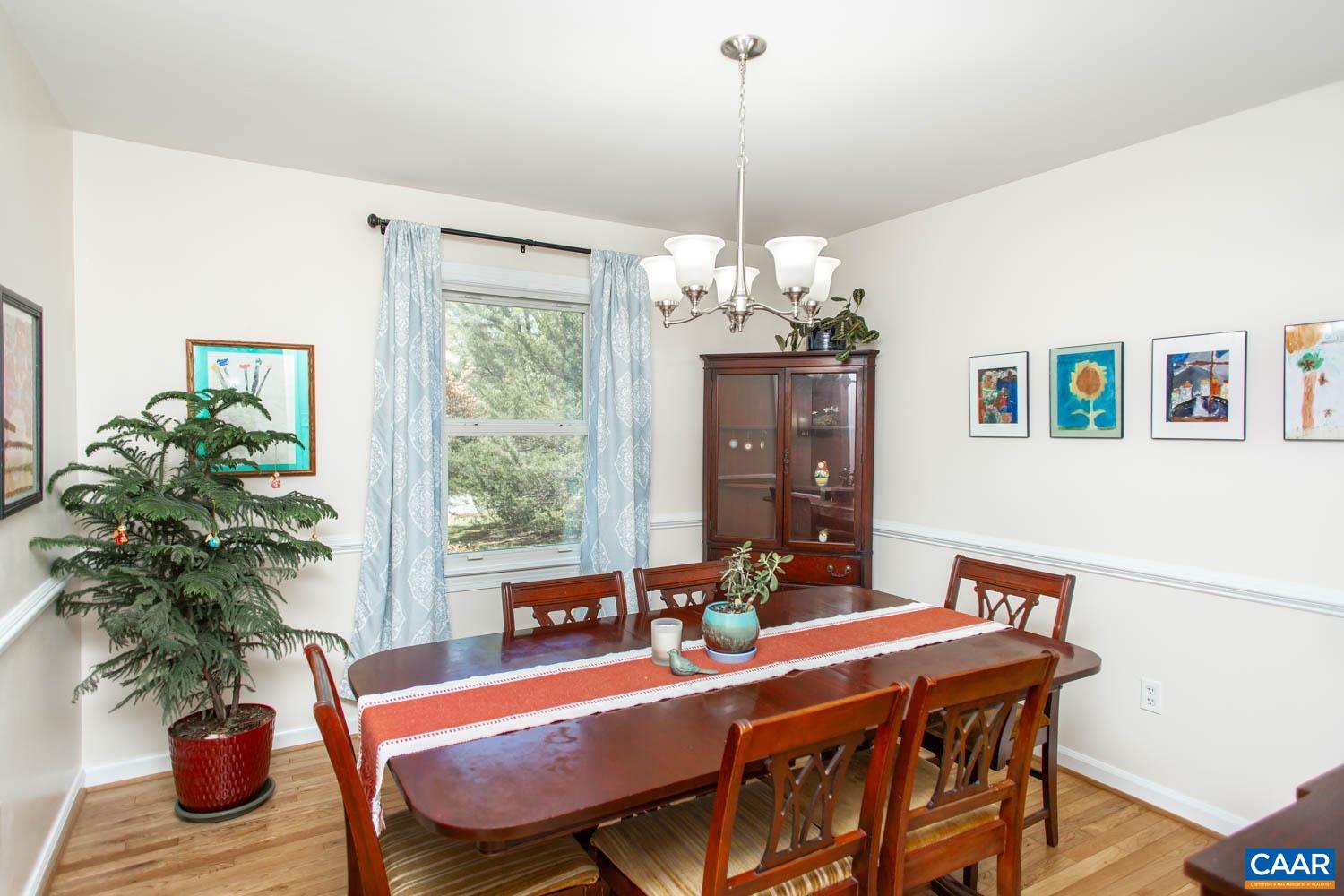 2750 Meriwether Drive Charlottesville, VA 22901 - Photo 13 of 52 a view of a dining room with furniture a chandelier and wooden floor