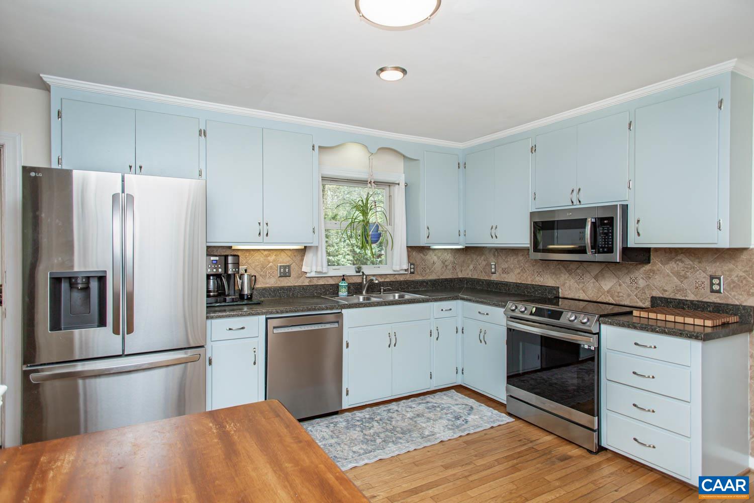 2750 Meriwether Drive Charlottesville, VA 22901 - Photo 14 of 52 a kitchen with white cabinets stainless steel appliances and a window