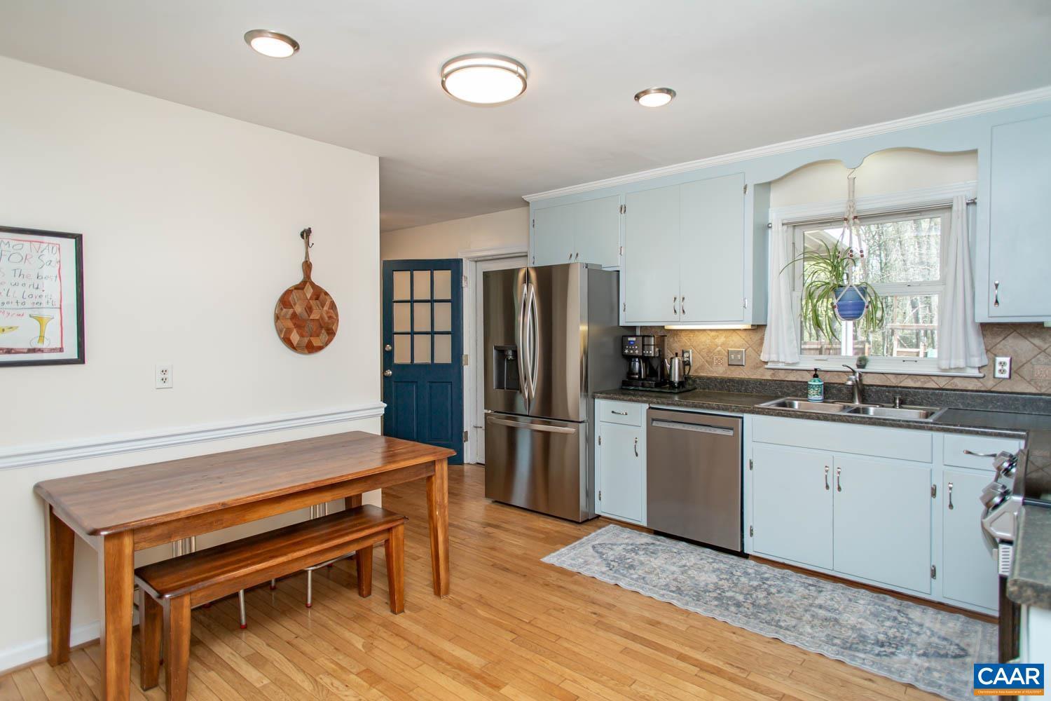 2750 Meriwether Drive Charlottesville, VA 22901 - Photo 15 of 52 a kitchen with stainless steel appliances kitchen island granite countertop a refrigerator a stove a sink and a dishwasher with wooden floor