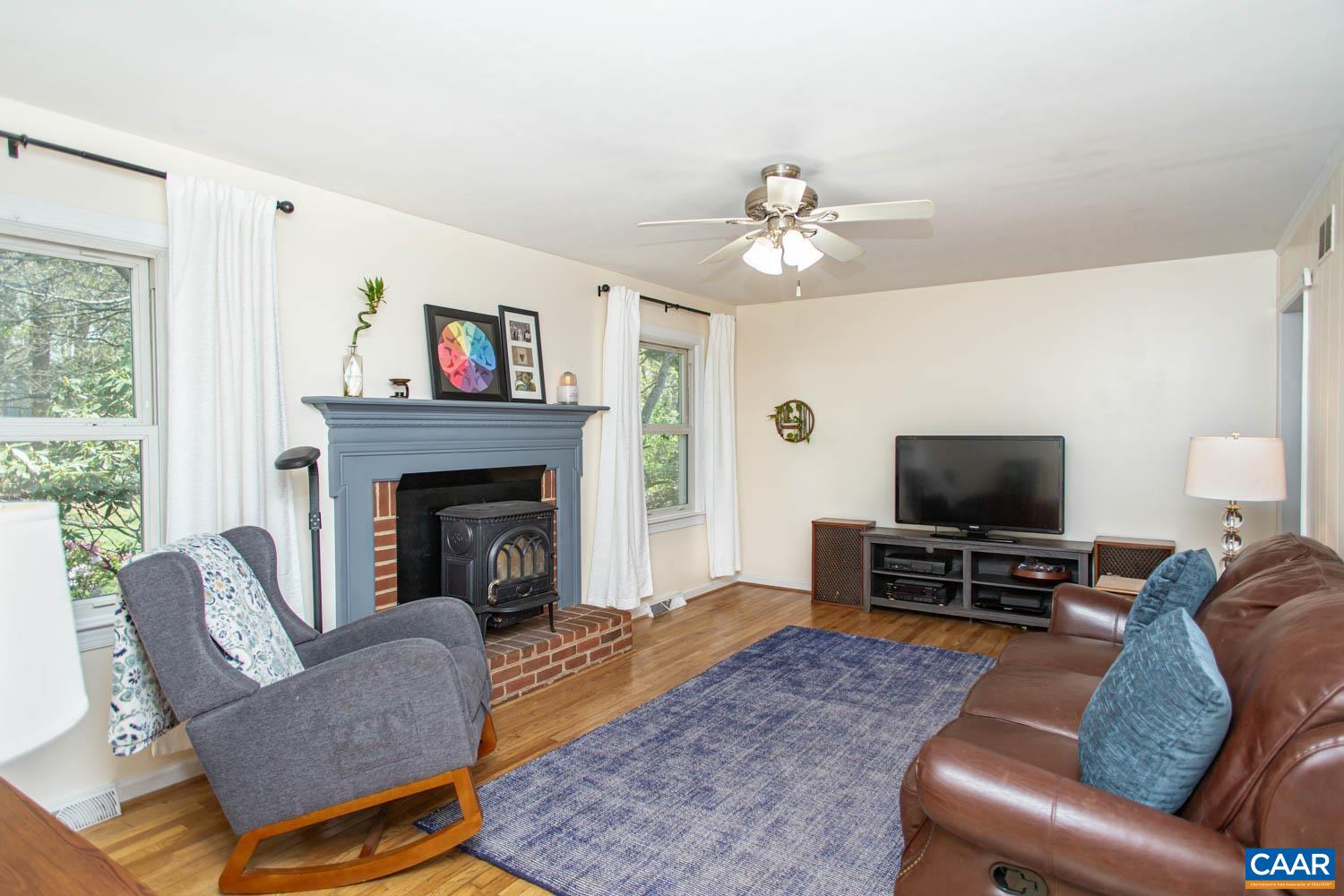 2750 Meriwether Drive Charlottesville, VA 22901 - Photo 20 of 52 a living room with furniture a flat screen tv and a fireplace