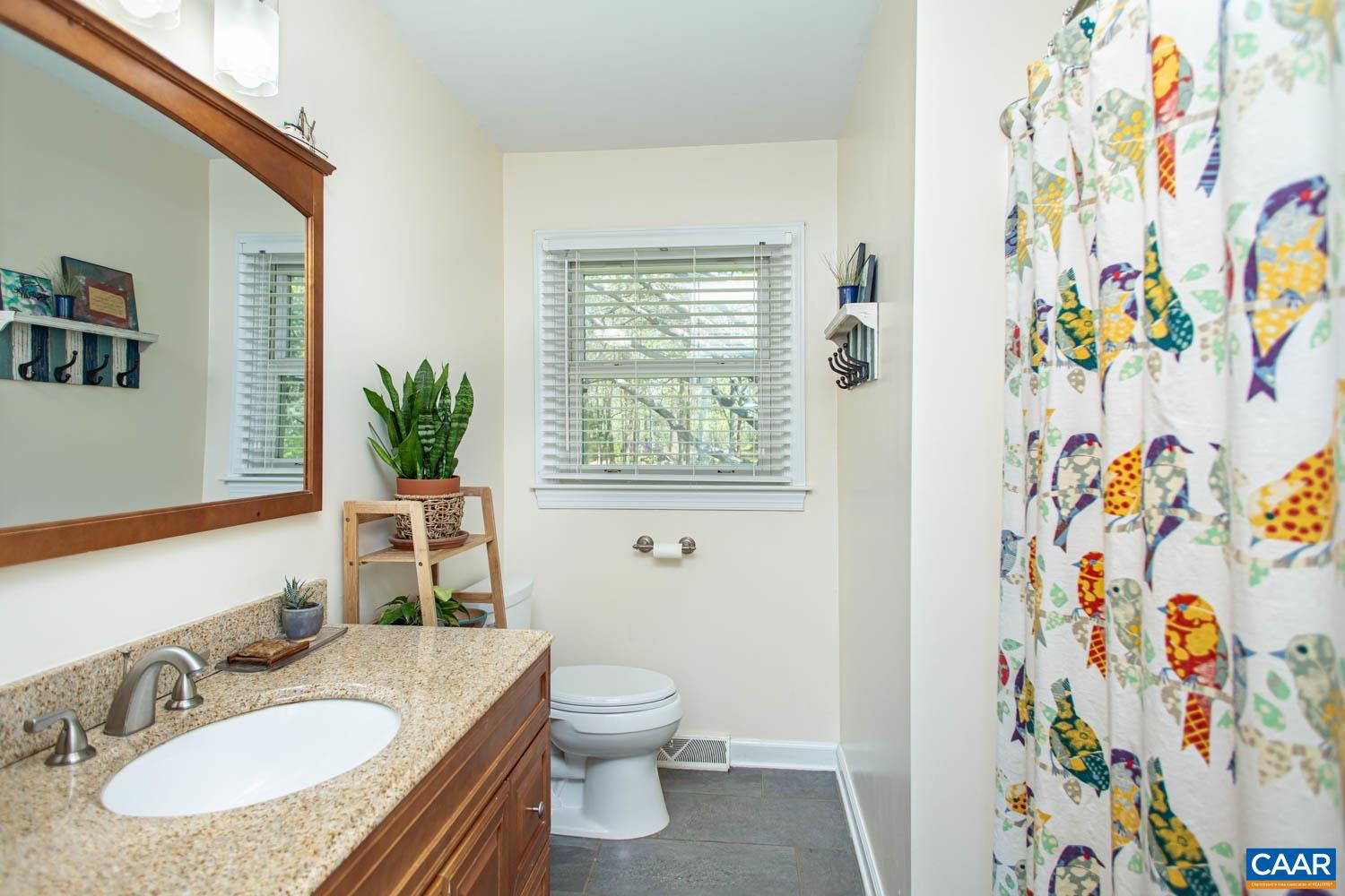 2750 Meriwether Drive Charlottesville, VA 22901 - Photo 24 of 52 a bathroom with a granite countertop sink and a mirror