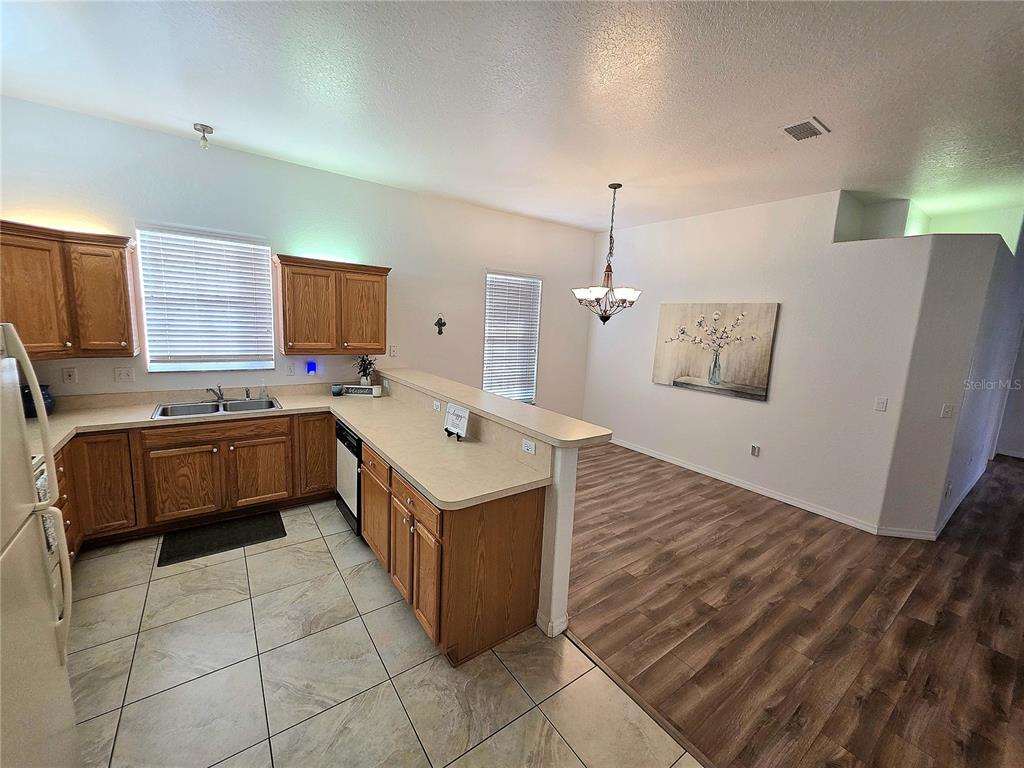 2116 Northeast 40th Terrace Ocala, FL 34470 - Photo 11 of 37 a kitchen with a sink counter top space a cabinetry and appliances