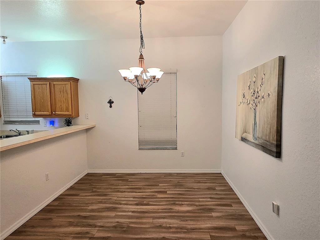 2116 Northeast 40th Terrace Ocala, FL 34470 - Photo 12 of 37 a view of a hallway with a chandelier