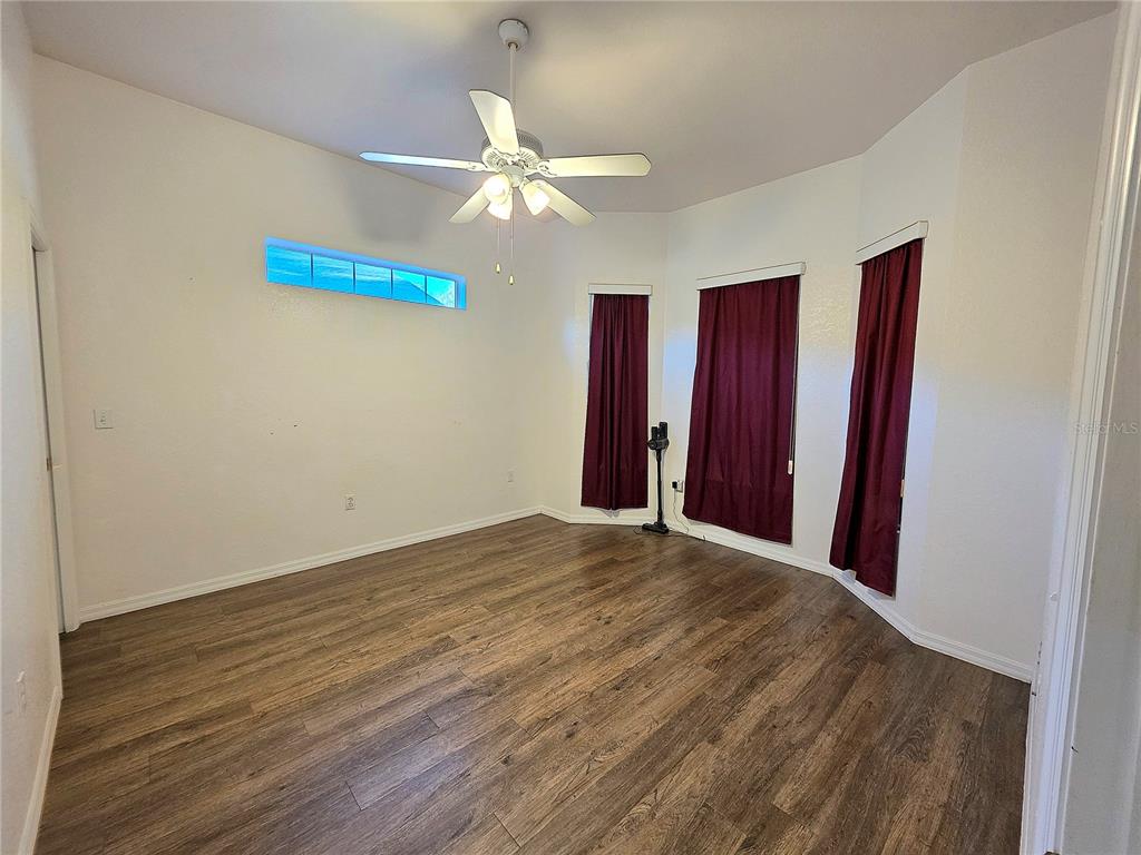 2116 Northeast 40th Terrace Ocala, FL 34470 - Photo 13 of 37 a view of a room with wooden floor and fan