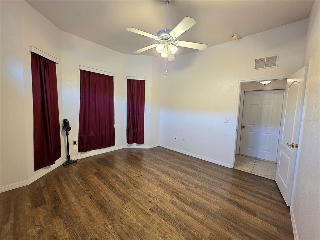 2116 Northeast 40th Terrace Ocala, FL 34470 - Photo 14 of 37 a view of an empty room with wooden floor