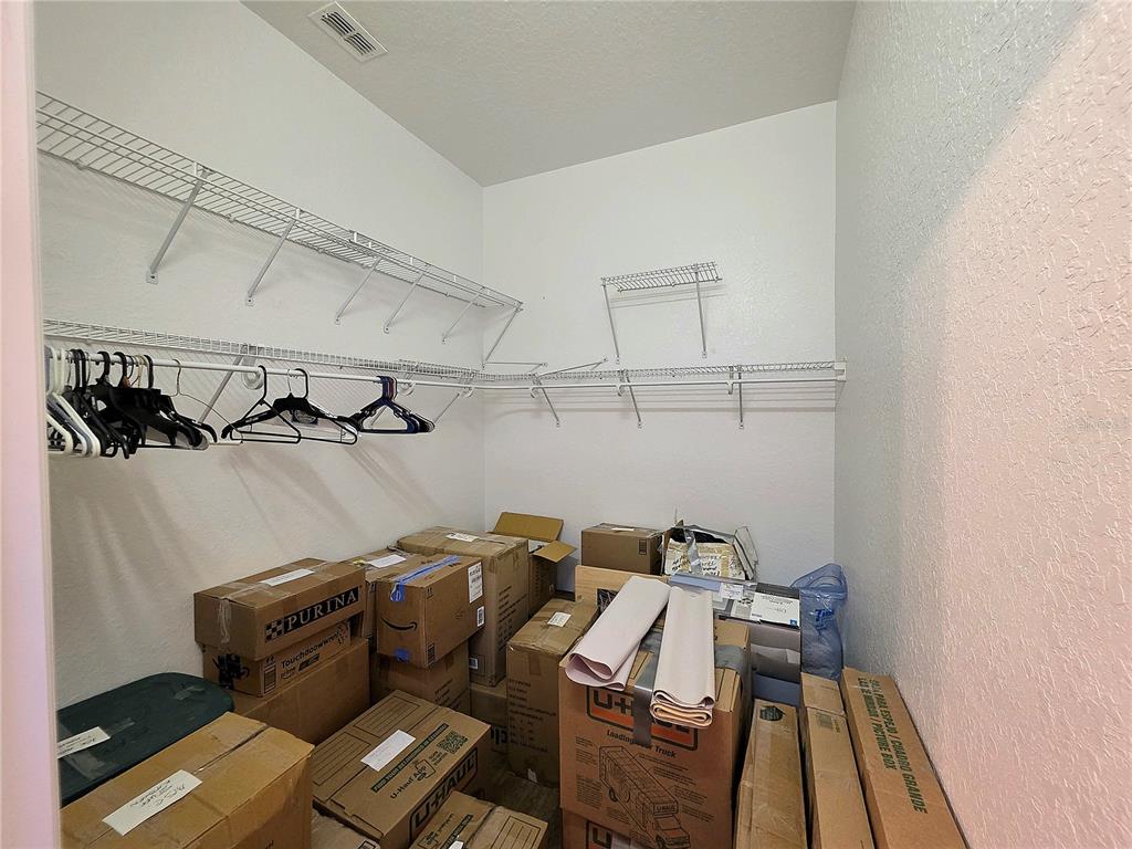 2116 Northeast 40th Terrace Ocala, FL 34470 - Photo 15 of 37 a view of walk in closet with clothes and shoes