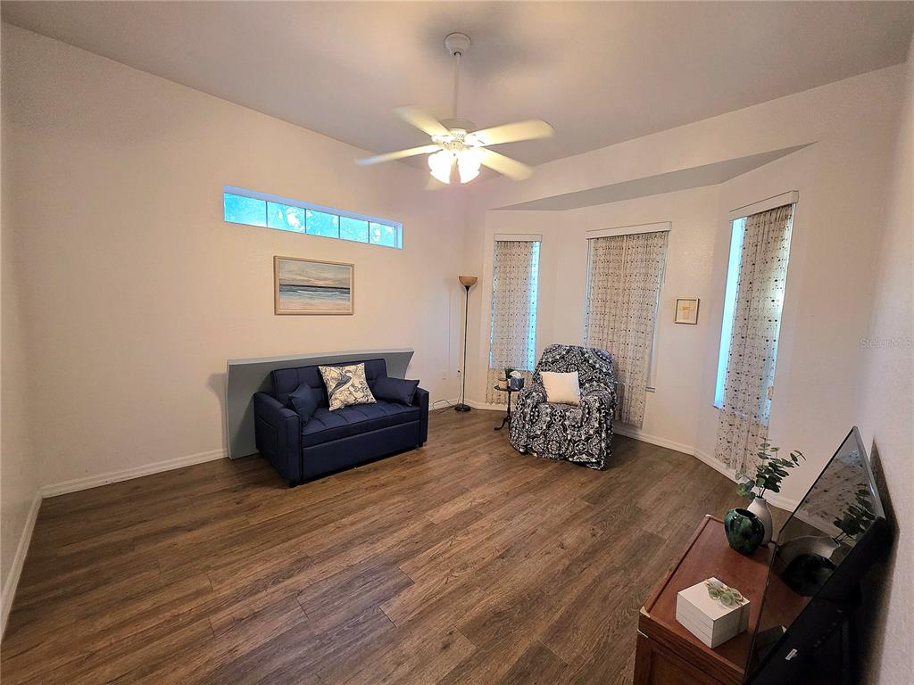 2116 Northeast 40th Terrace Ocala, FL 34470 - Photo 18 of 37 a living room with furniture and a chandelier