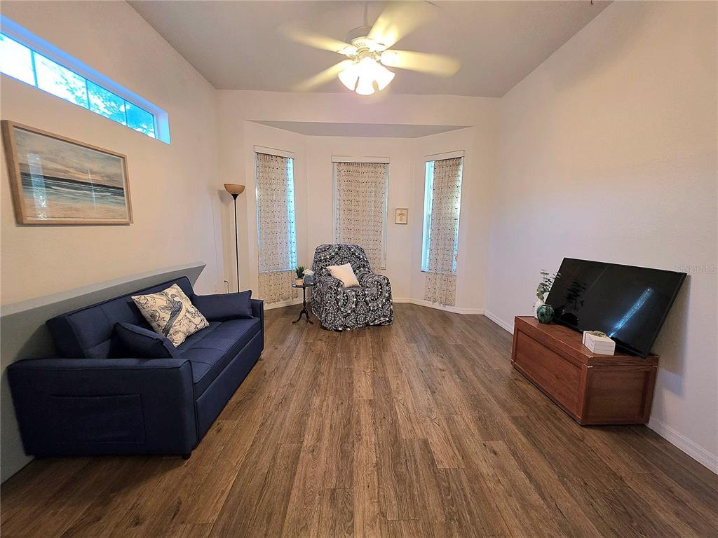 2116 Northeast 40th Terrace Ocala, FL 34470 - Photo 19 of 37 a living room with furniture and a flat screen tv