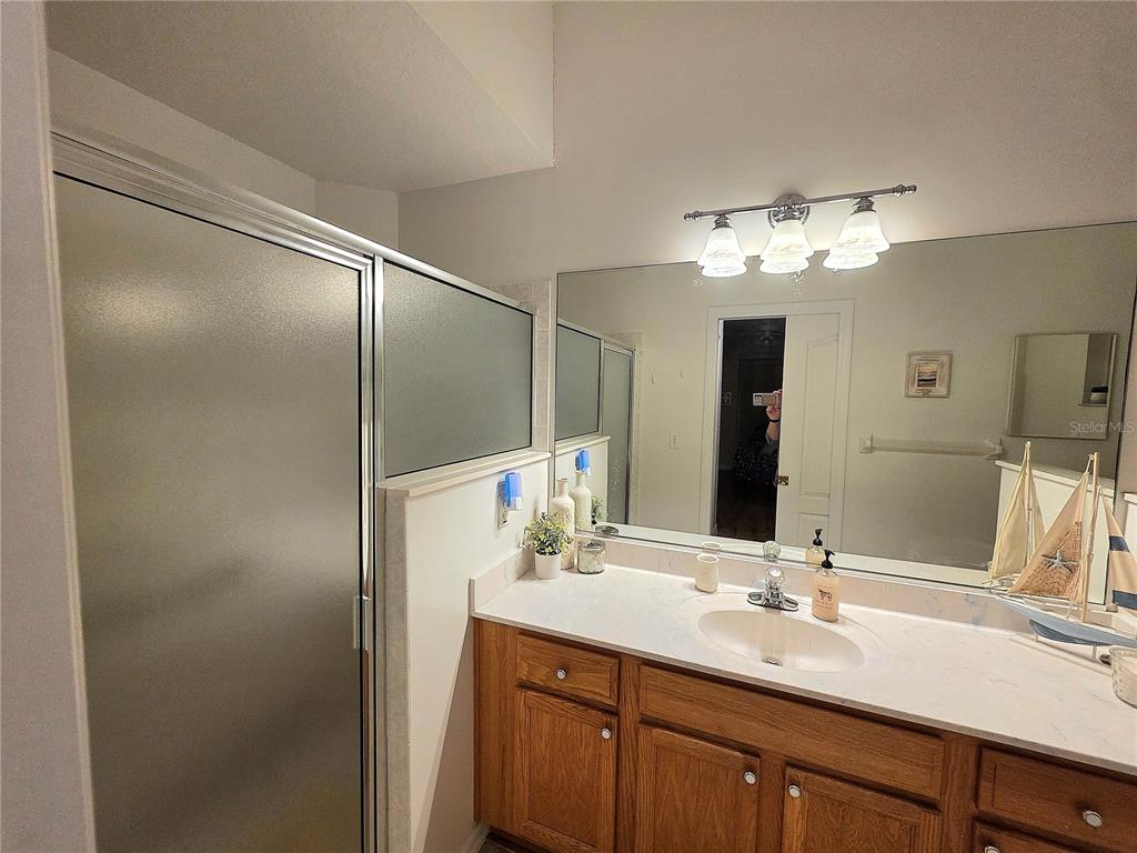 2116 Northeast 40th Terrace Ocala, FL 34470 - Photo 21 of 37 a bathroom with a double vanity sink and a mirror
