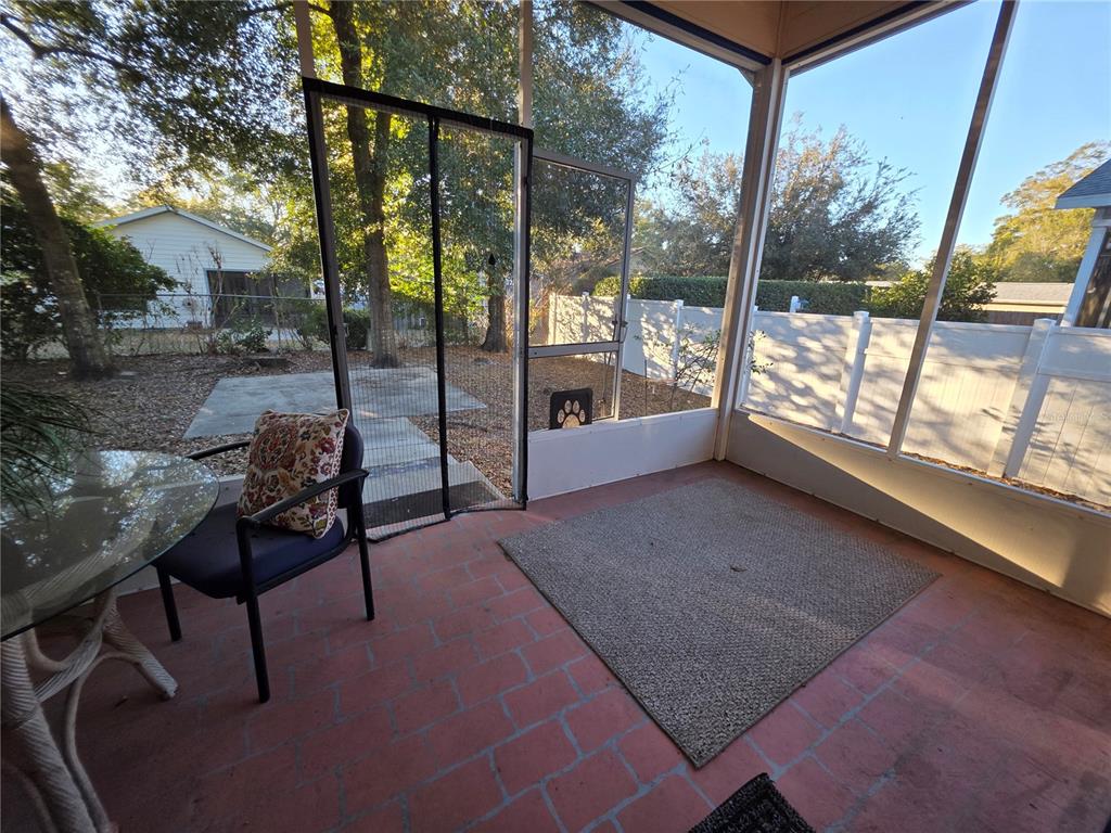 2116 Northeast 40th Terrace Ocala, FL 34470 - Photo 29 of 37 a view of a porch with chairs and backyard