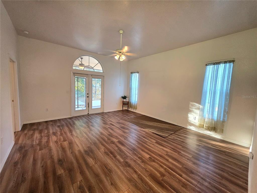 2116 Northeast 40th Terrace Ocala, FL 34470 - Photo 4 of 37 wooden floor in an empty room with a window