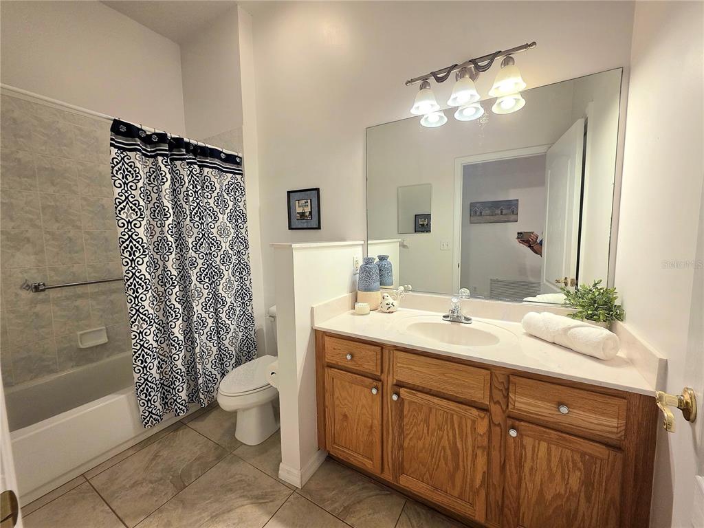 2116 Northeast 40th Terrace Ocala, FL 34470 - Photo 5 of 37 a spacious bathroom with a double vanity sink mirror and toilet