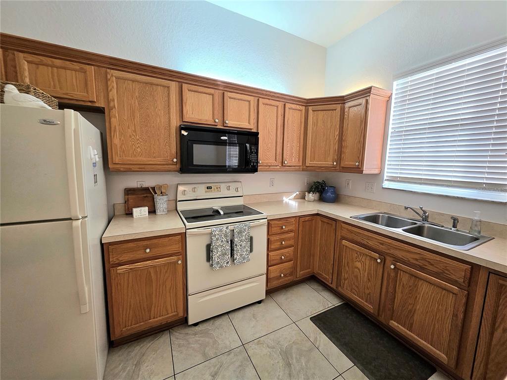 2116 Northeast 40th Terrace Ocala, FL 34470 - Photo 9 of 37 a kitchen with a sink stove and refrigerator
