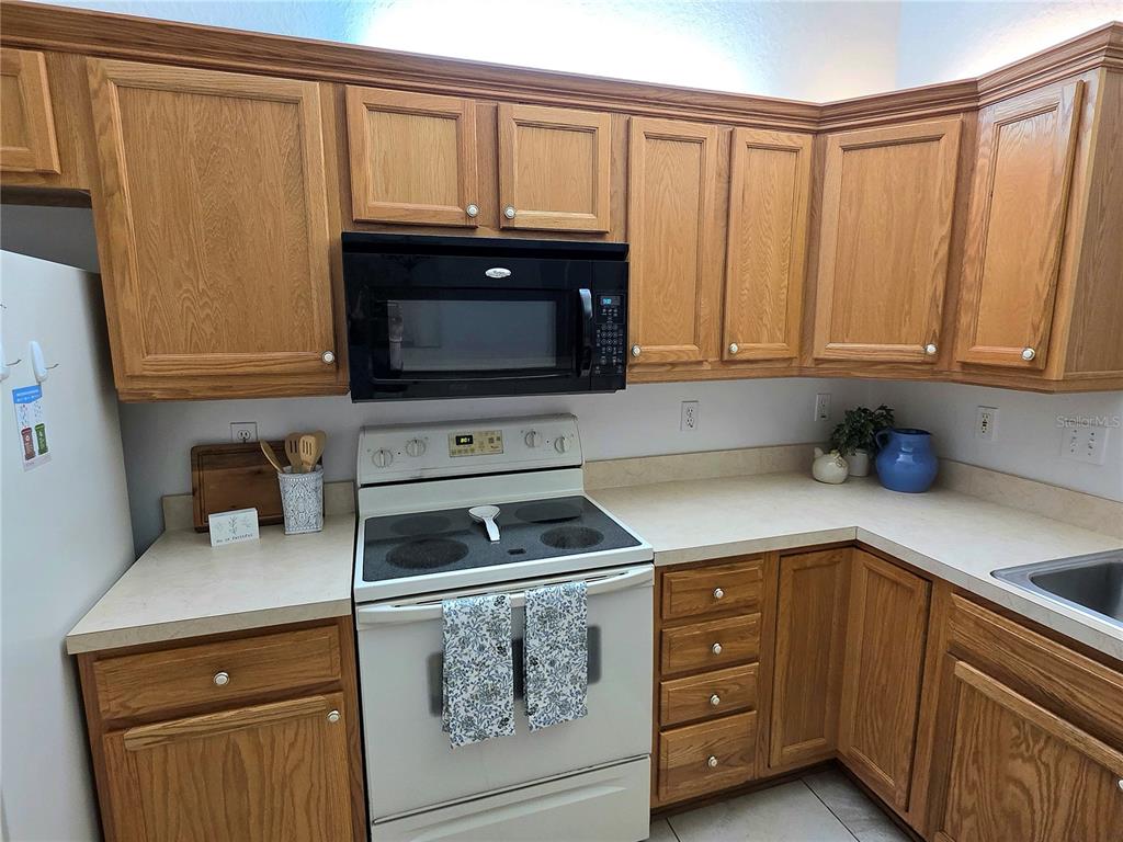 2116 Northeast 40th Terrace Ocala, FL 34470 - Photo 10 of 37 a kitchen with granite countertop cabinets stainless steel appliances and a sink
