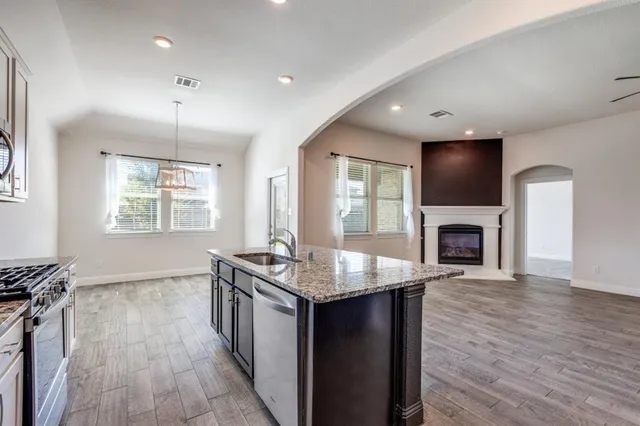 wooden floor in an empty room with a fireplace