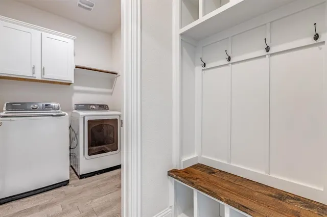 a kitchen with stainless steel appliances granite countertop a stove top oven a sink and dishwasher a refrigerator with wooden floors