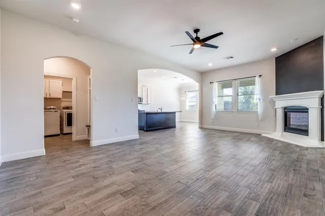 a large kitchen with lots of furniture and stainless steel appliances