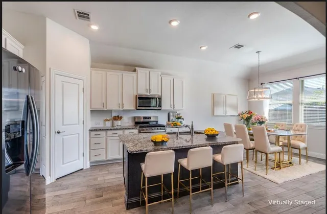 an empty room with windows and fireplace