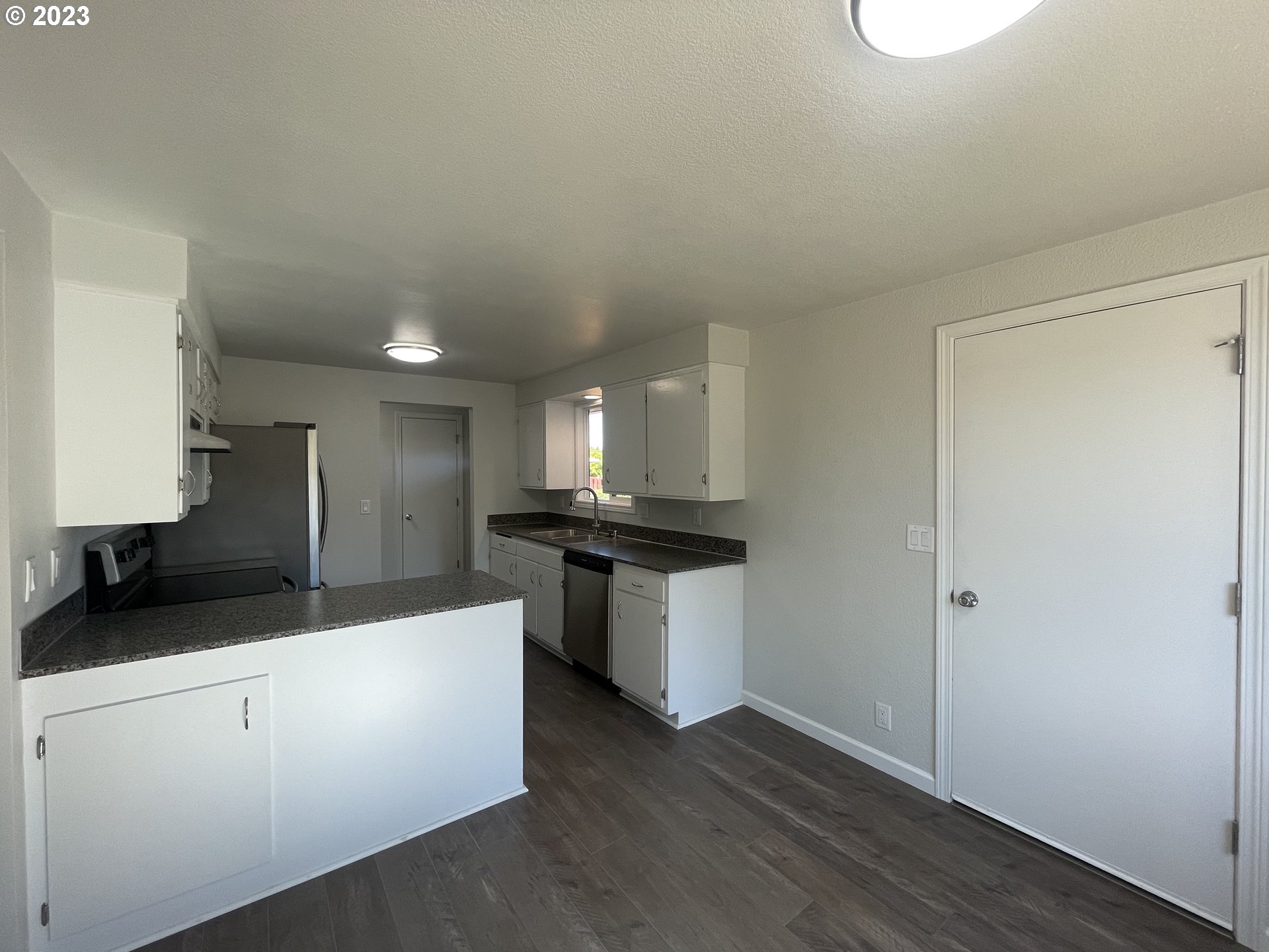 3776 Cherokee Drive Springfield, OR 97478 - Photo 7 of 34 a kitchen with stainless steel appliances a sink stove and cabinets