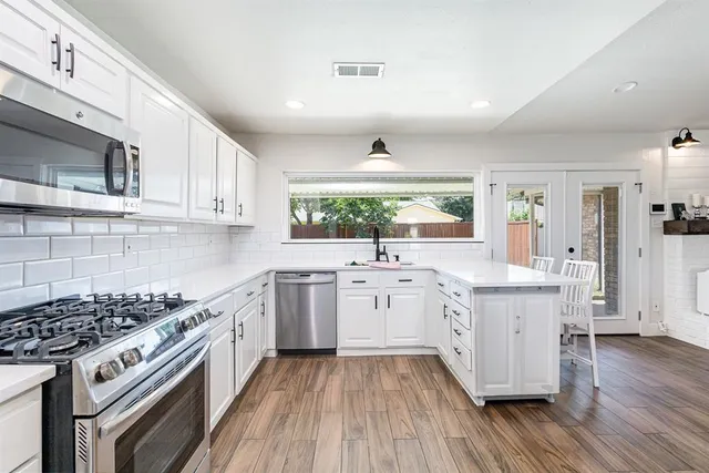 a kitchen with a sink stove and wooden cabinets