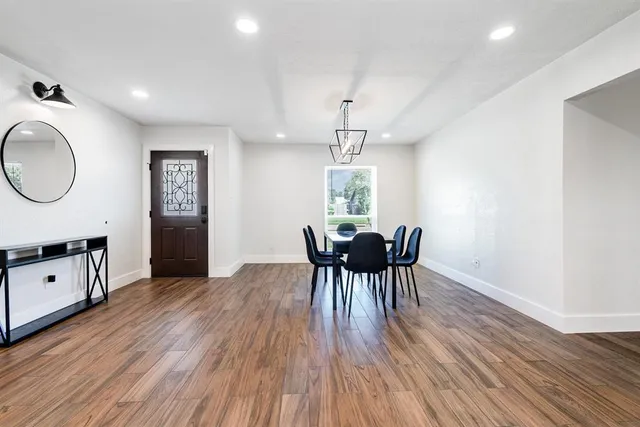a kitchen with a refrigerator a sink and wooden floor