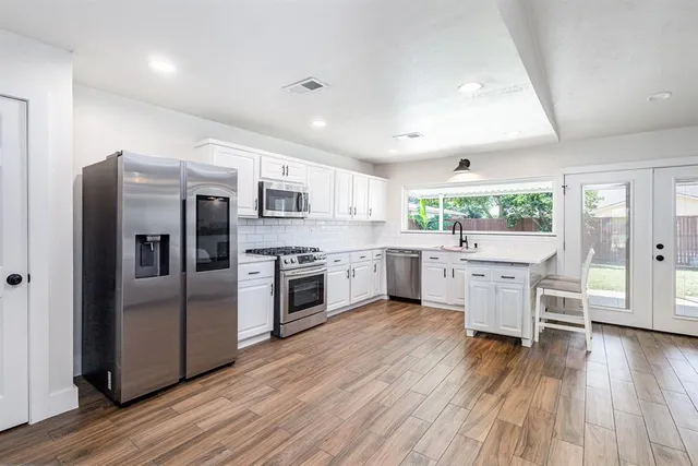 a view of a workspace with furniture and wooden floor