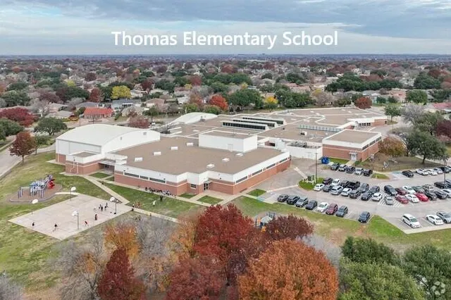 an aerial view of residential houses with outdoor space and street view