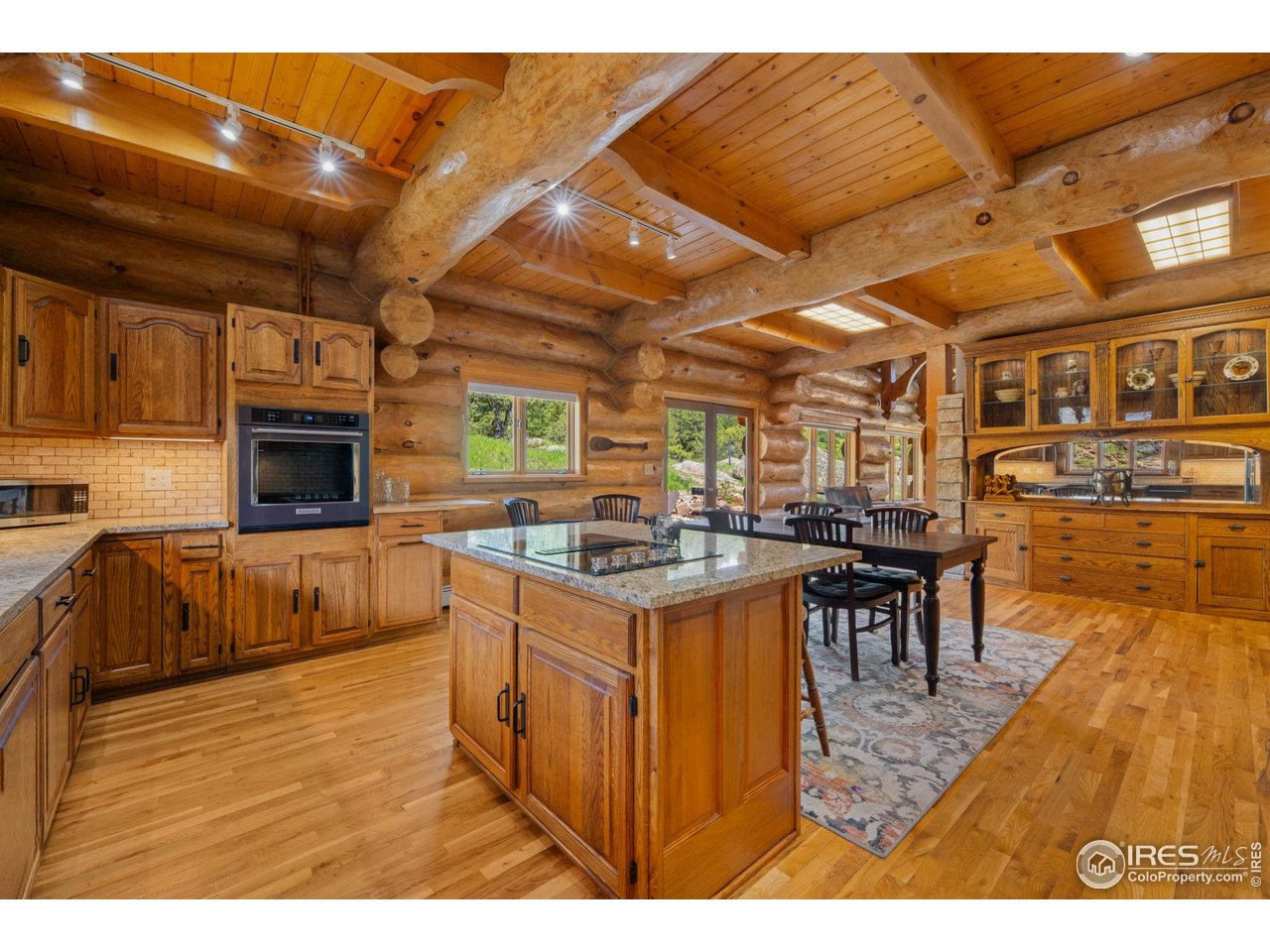 95 Choctaw Road Lyons, CO 80540 - Photo 11 of 40 a open kitchen with stainless steel appliances granite countertop a stove and a wooden cabinets