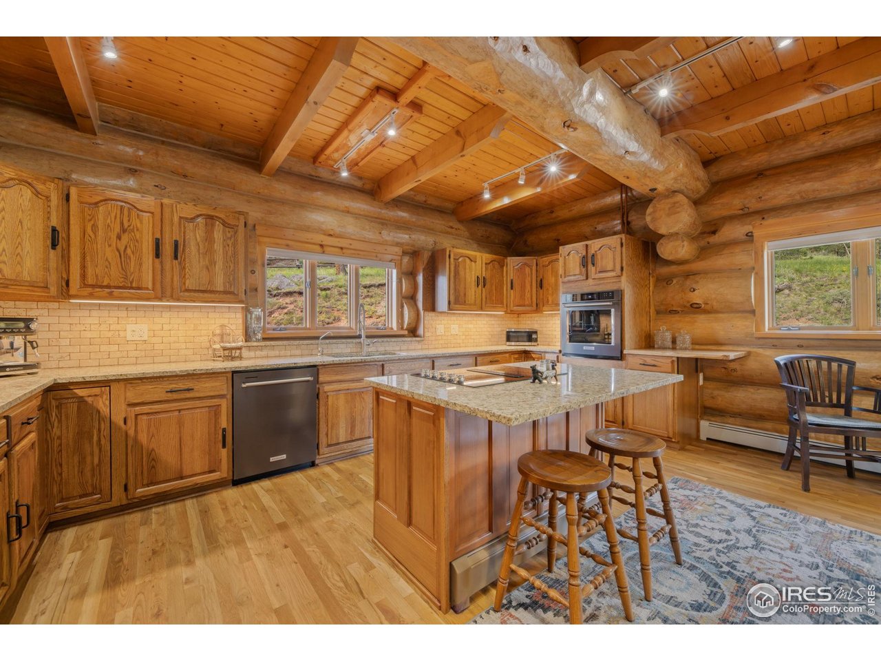 95 Choctaw Road Lyons, CO 80540 - Photo 2 of 40 a kitchen with stainless steel appliances granite countertop a stove a sink dishwasher and cabinets with wooden floor