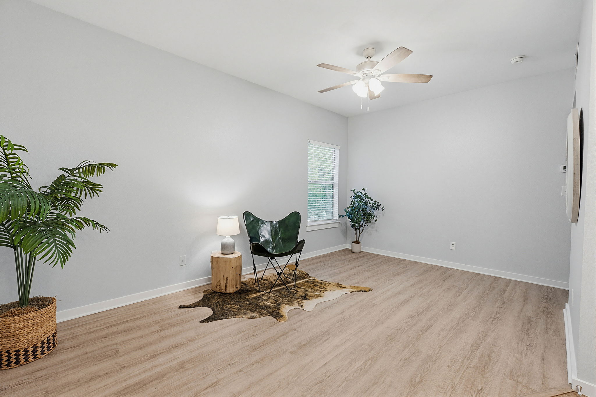2106 Cullen Avenue, Unit 206 Austin, TX 78757 - Photo 8 of 20 Spacious living room with updated paint, wood-look vinyl flooring and flexible living/furniture placement options.