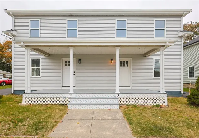 a view of a house with a yard and garage