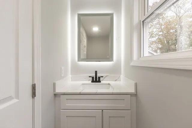 a bathroom with a sink and a mirror