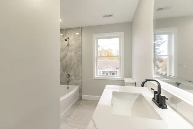 a bathroom with a bathtub and a sink