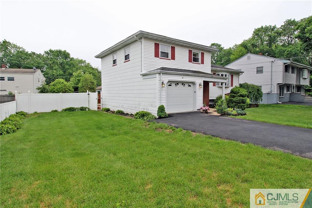 5 Delmar Place Edison, NJ 08837 - Photo 2 of 25 a front view of a house with a garden and yard