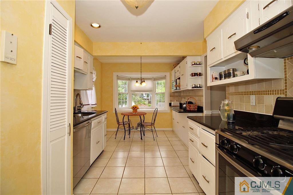 5 Delmar Place Edison, NJ 08837 - Photo 11 of 25 a kitchen with stainless steel appliances a stove a sink and cabinets