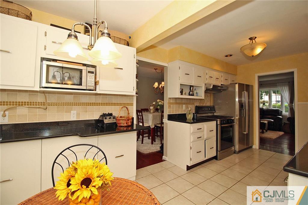 5 Delmar Place Edison, NJ 08837 - Photo 12 of 25 a view of a kitchen with a sink and a refrigerator