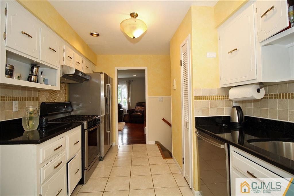 5 Delmar Place Edison, NJ 08837 - Photo 13 of 25 a kitchen with a sink and a stove top oven