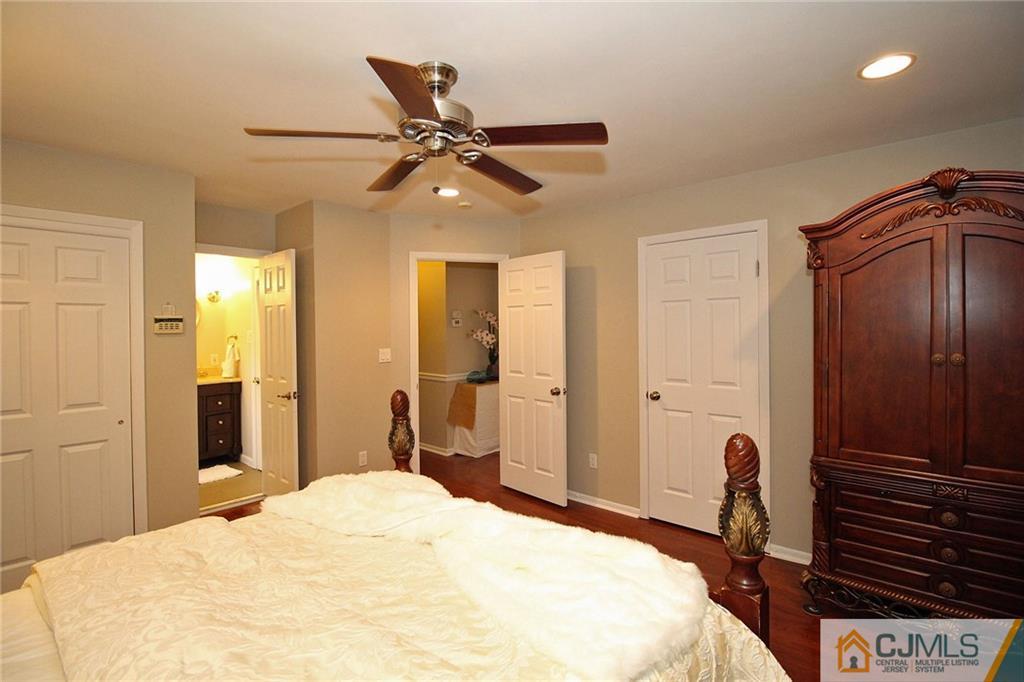 5 Delmar Place Edison, NJ 08837 - Photo 16 of 25 a bedroom with a bed and a chandelier