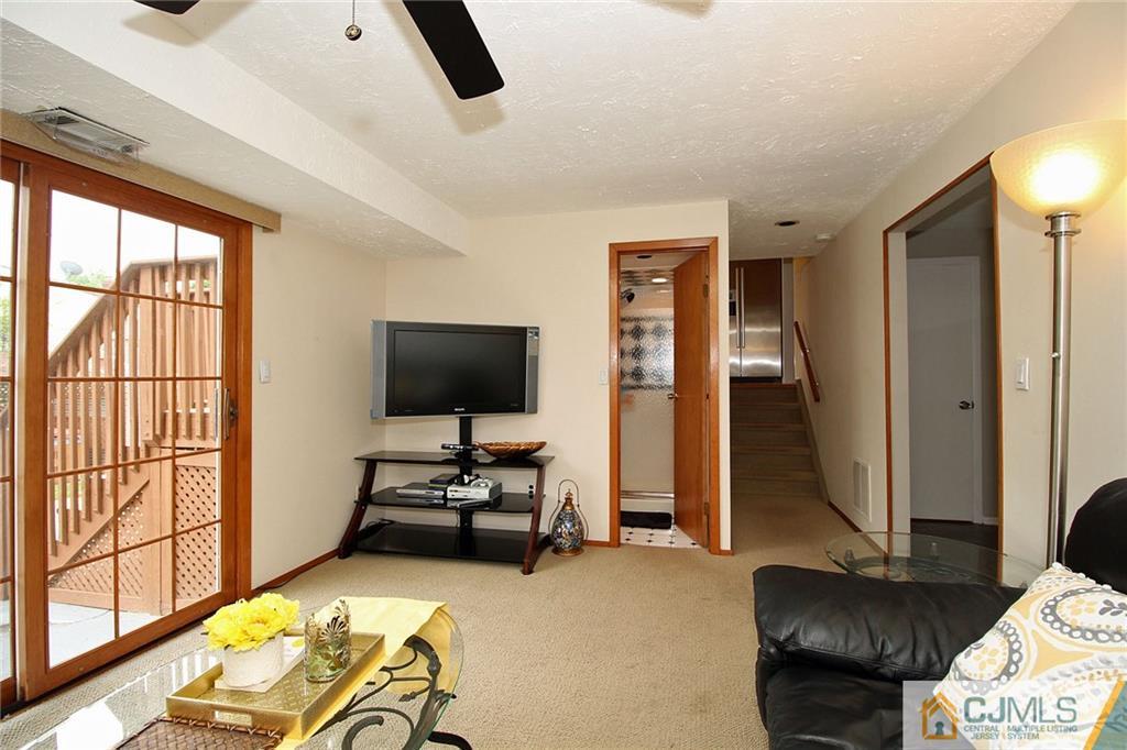 5 Delmar Place Edison, NJ 08837 - Photo 21 of 25 a living room with furniture and a flat screen tv