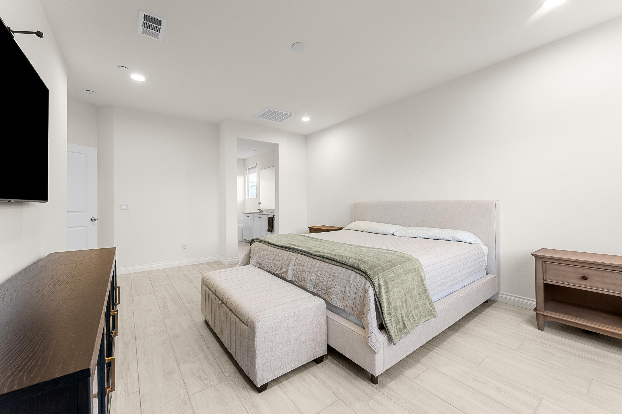 84458 Calle Larriva Coachella, CA 92236 - Photo 21 of 43 a spacious bedroom with a bed and a flat screen tv