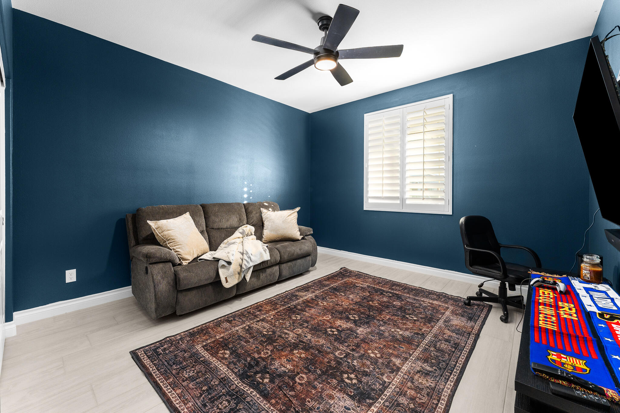 84458 Calle Larriva Coachella, CA 92236 - Photo 28 of 43 a living room with a couch and a flat screen tv