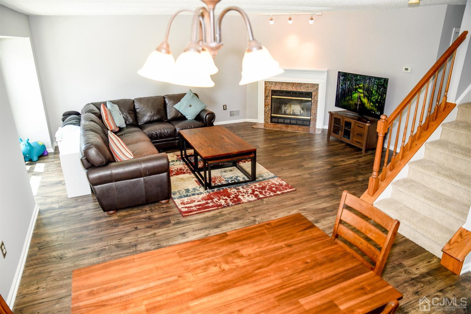 4206 Riddle Court Bridgewater, NJ 08807 - Photo 11 of 25 a living room with furniture a fireplace and a table