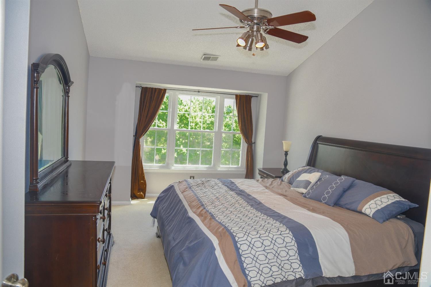 4206 Riddle Court Bridgewater, NJ 08807 - Photo 17 of 25 a bedroom with a bed and a mirror