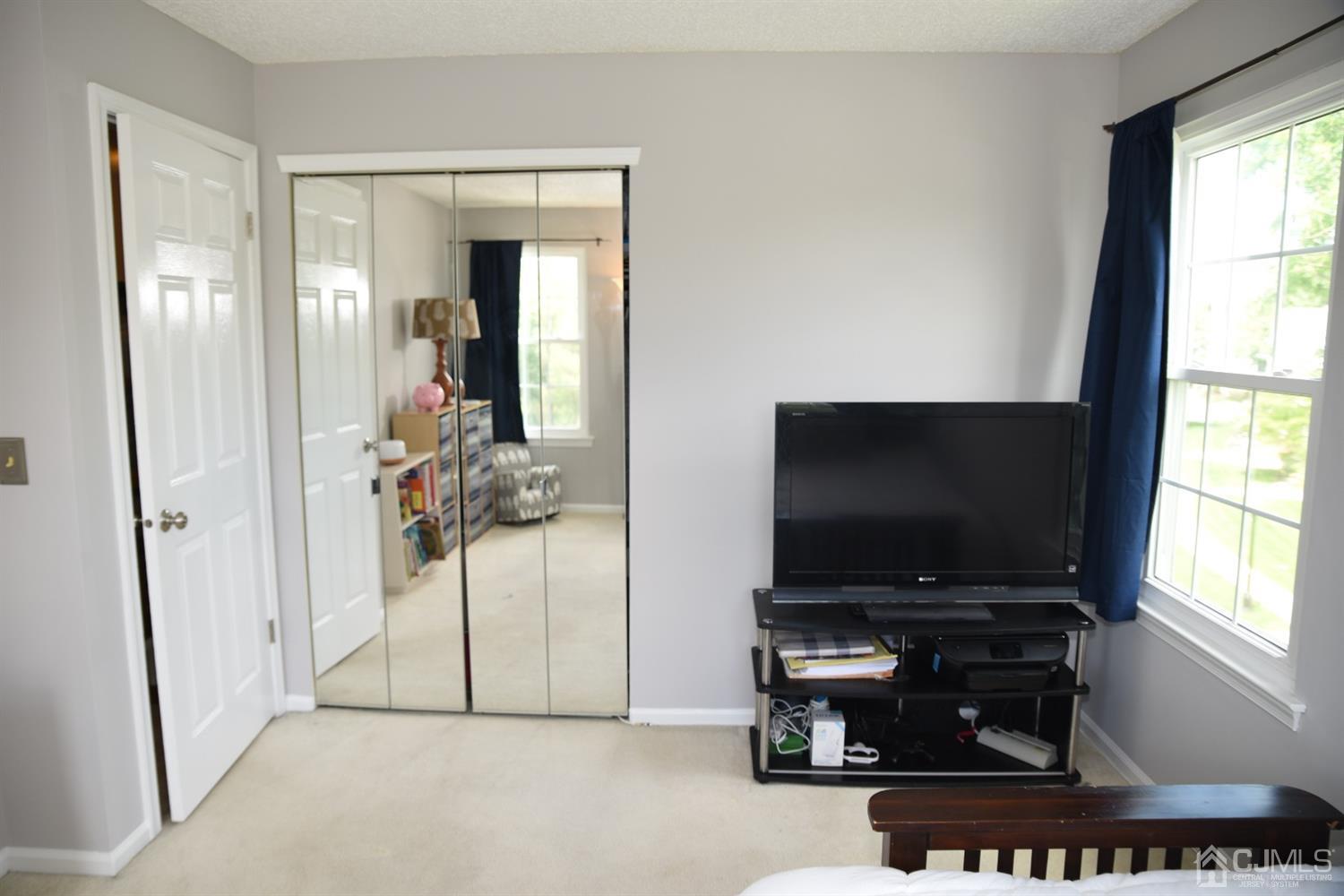 4206 Riddle Court Bridgewater, NJ 08807 - Photo 22 of 25 a living room with furniture and a flat screen tv