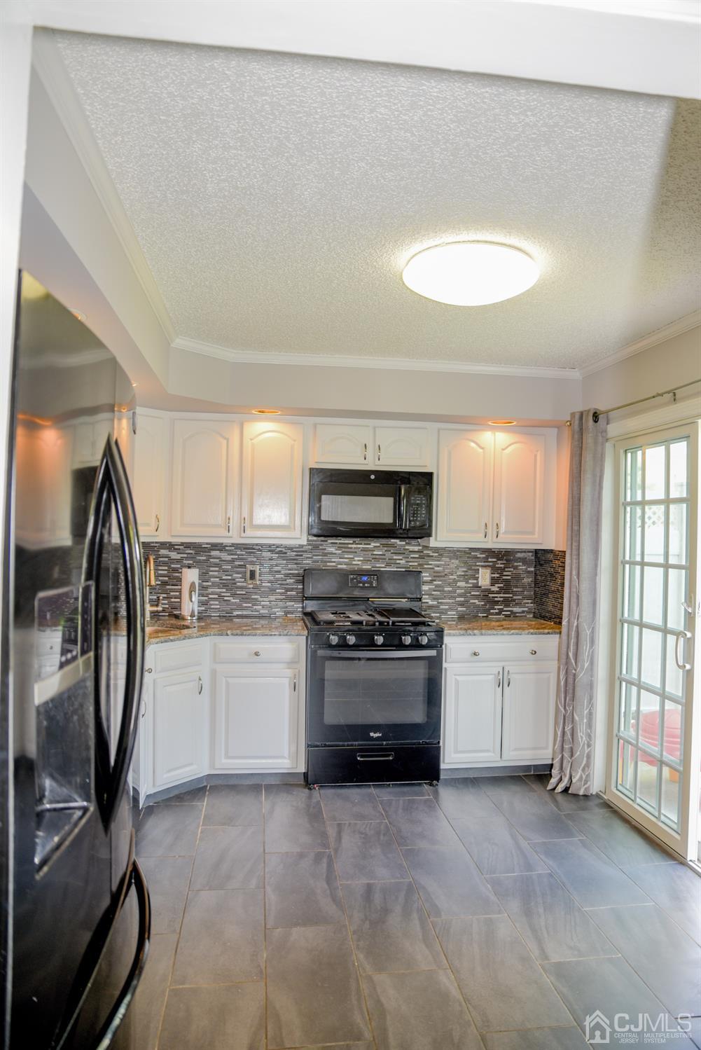 4206 Riddle Court Bridgewater, NJ 08807 - Photo 5 of 25 a kitchen with a stove a sink and a refrigerator