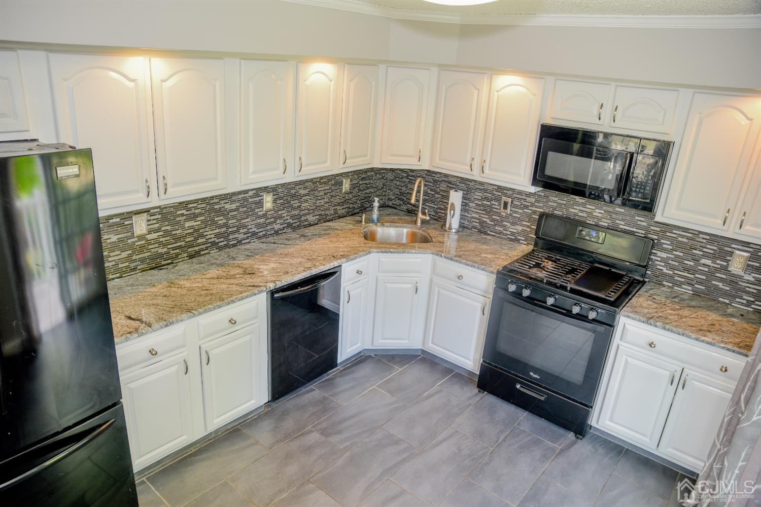 4206 Riddle Court Bridgewater, NJ 08807 - Photo 6 of 25 a kitchen with granite countertop a sink stove and refrigerator