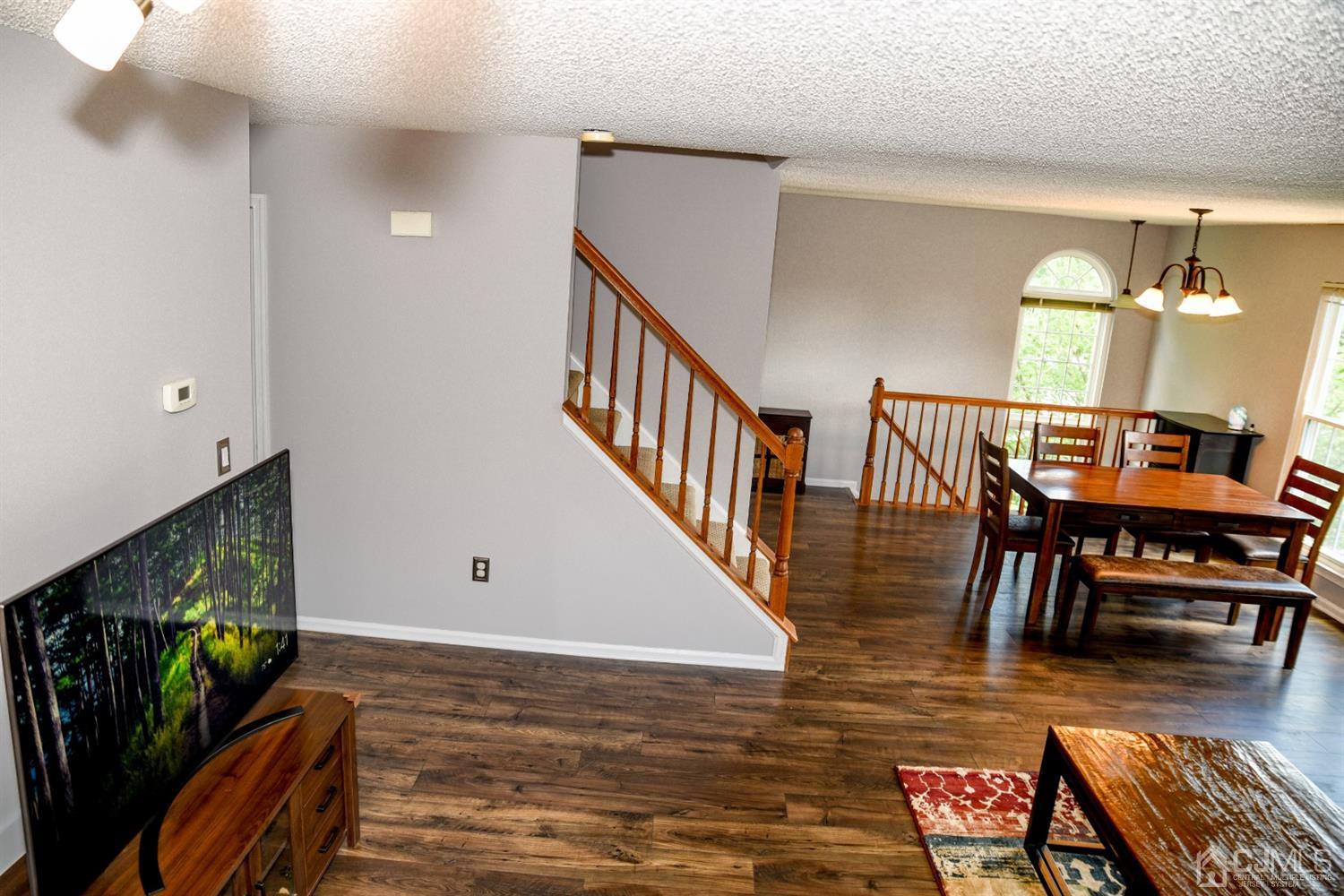 4206 Riddle Court Bridgewater, NJ 08807 - Photo 9 of 25 a view of a livingroom with furniture hardwood floor and a flat screen tv