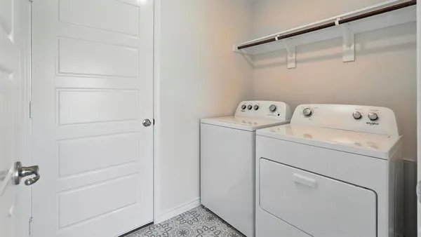 a view of storage and utility room with washer and dryer