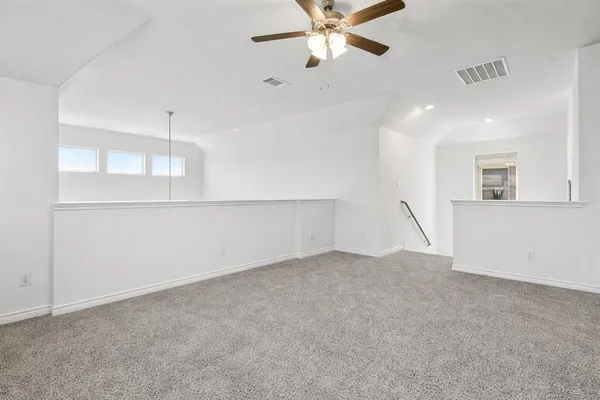 an empty room with a empty space and windows