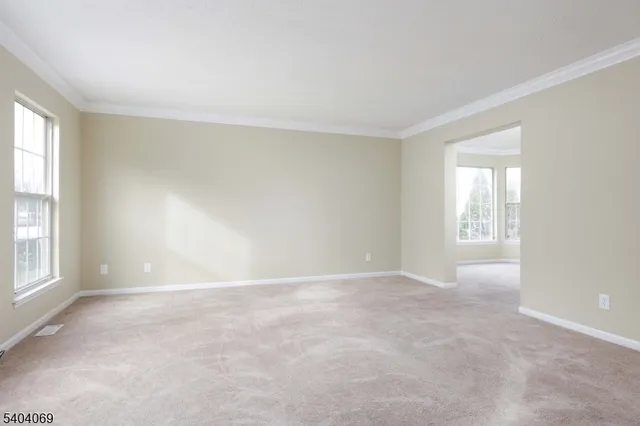 an empty room with staircase and white walls